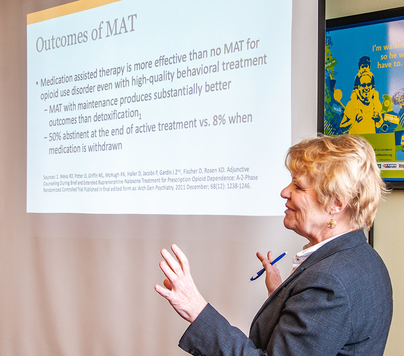 Professional trainer presents training slideshow on medication-assisted treatment.